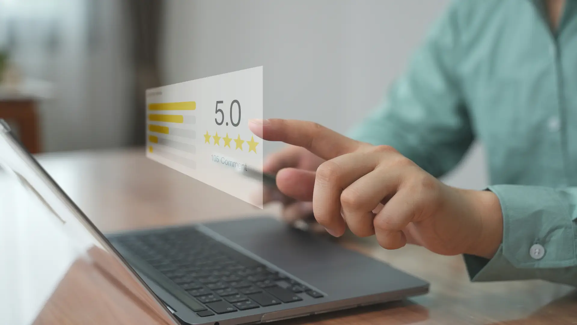 Person leaving a five-star review on a laptop